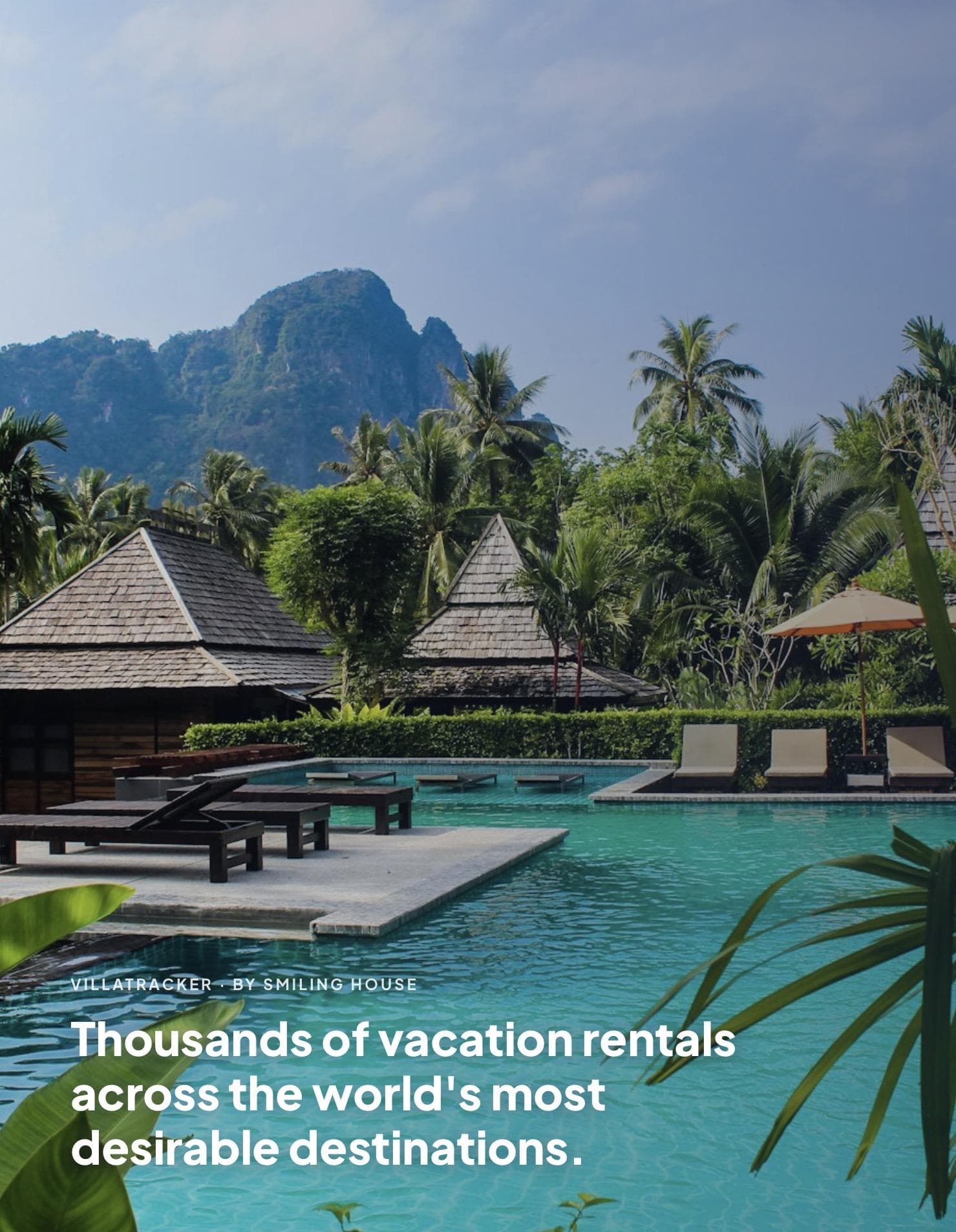 A resort pool below thatched pavilions, palms and a jungled limestone peak, captioned